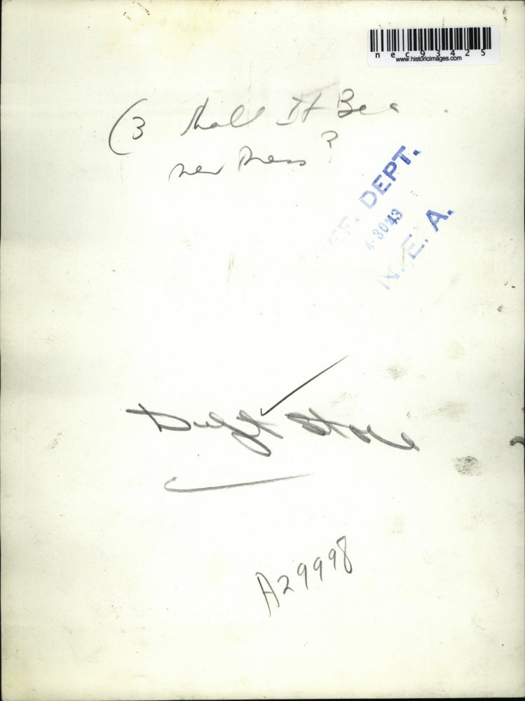 1943 Press Photo A woman & man as she tries gowns at a store