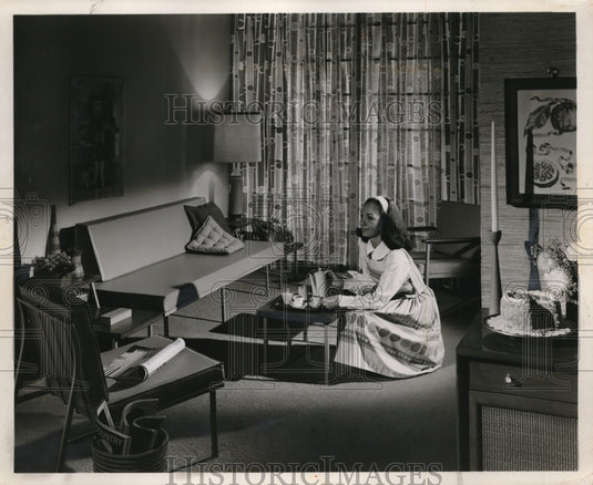 1960 Press Photo A woman in a home's living room with coffee service- Historic Images
