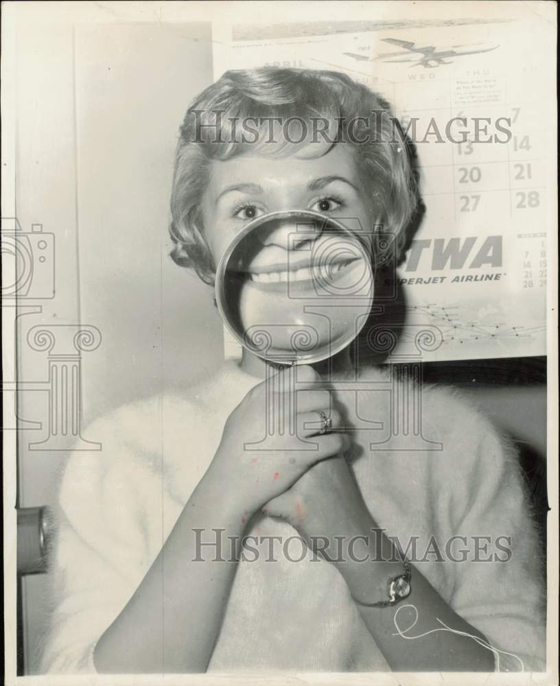 1961 Press Photo TWA employee Melanie Lehman magnifies her smile, Los Angeles- Historic Images