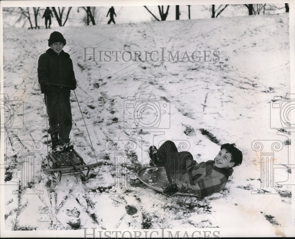 1956 Press Photo Larry Lee, Doug Mulholland sledding in Cain Park, OH