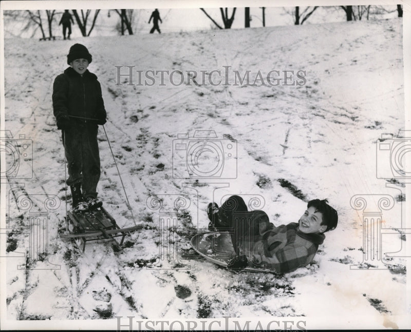 Load image into Gallery viewer, 1956 Press Photo Larry Lee, Doug Mulholland sledding in Cain Park, OH
