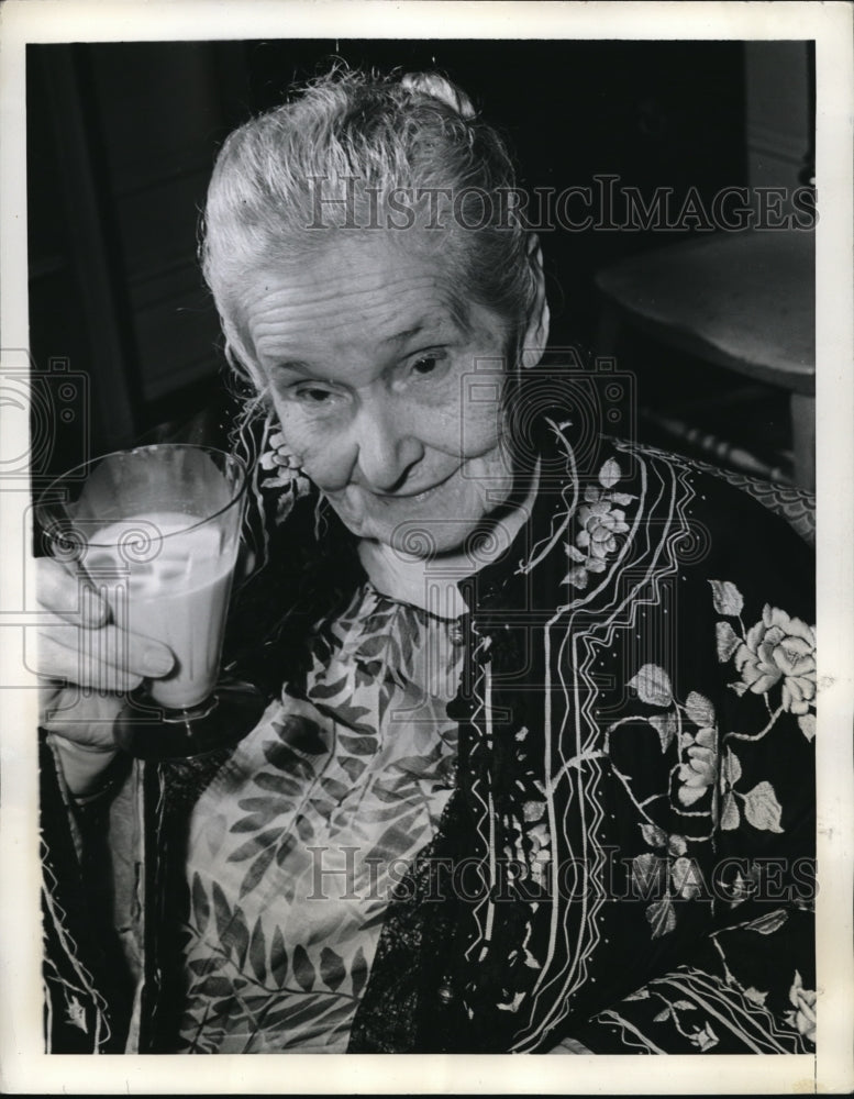 1941 Press Photo Mrs. James toasts to the next 100 years with a glass of milk