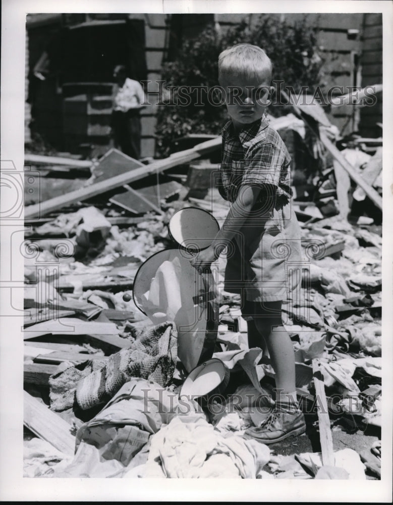 1953 Press Photo Larry Eby, 6, pulls toys from wreckage after tornado