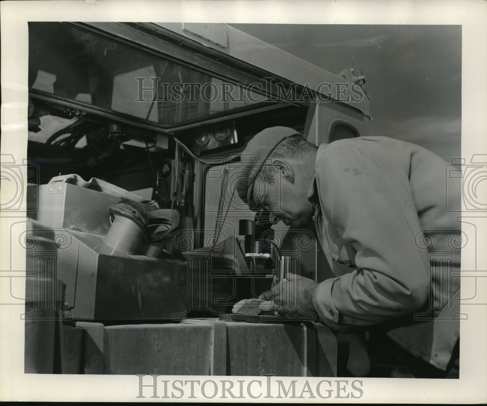 1955 Press Photo Campbell at a microscope work for a rock sample - nec97045