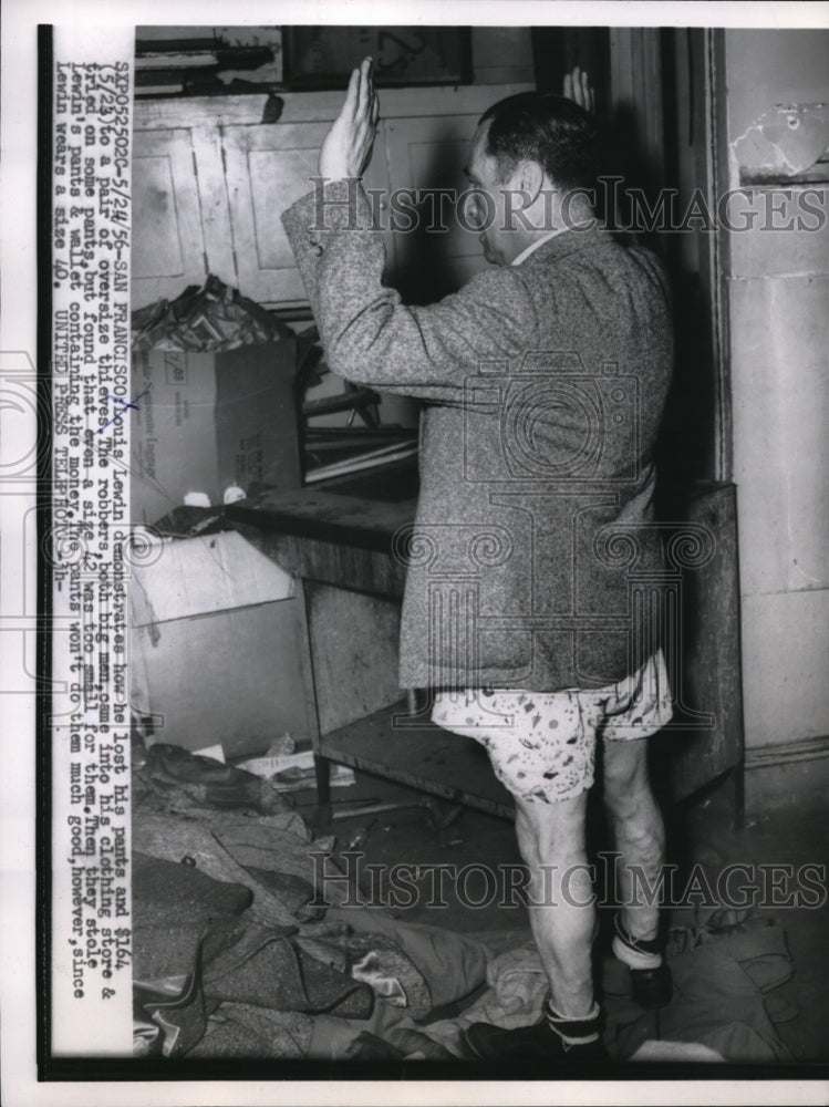 1956 Press Photo Louis Lewin demonstrates how he lost his pants in a robbery.