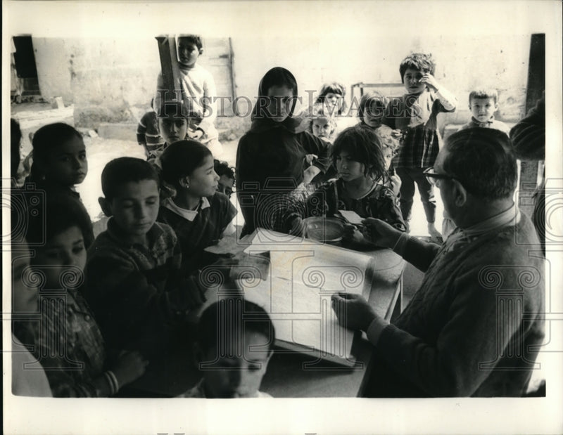 Load image into Gallery viewer, 1969 Press Photo Refugees waits for the food to be served by U.N. Refugee worker
