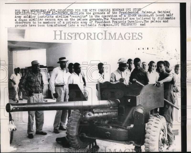 Load image into Gallery viewer, 1959 Press Photo Haitian Army Soldier Instructs Civilian Recruits of Cannon
