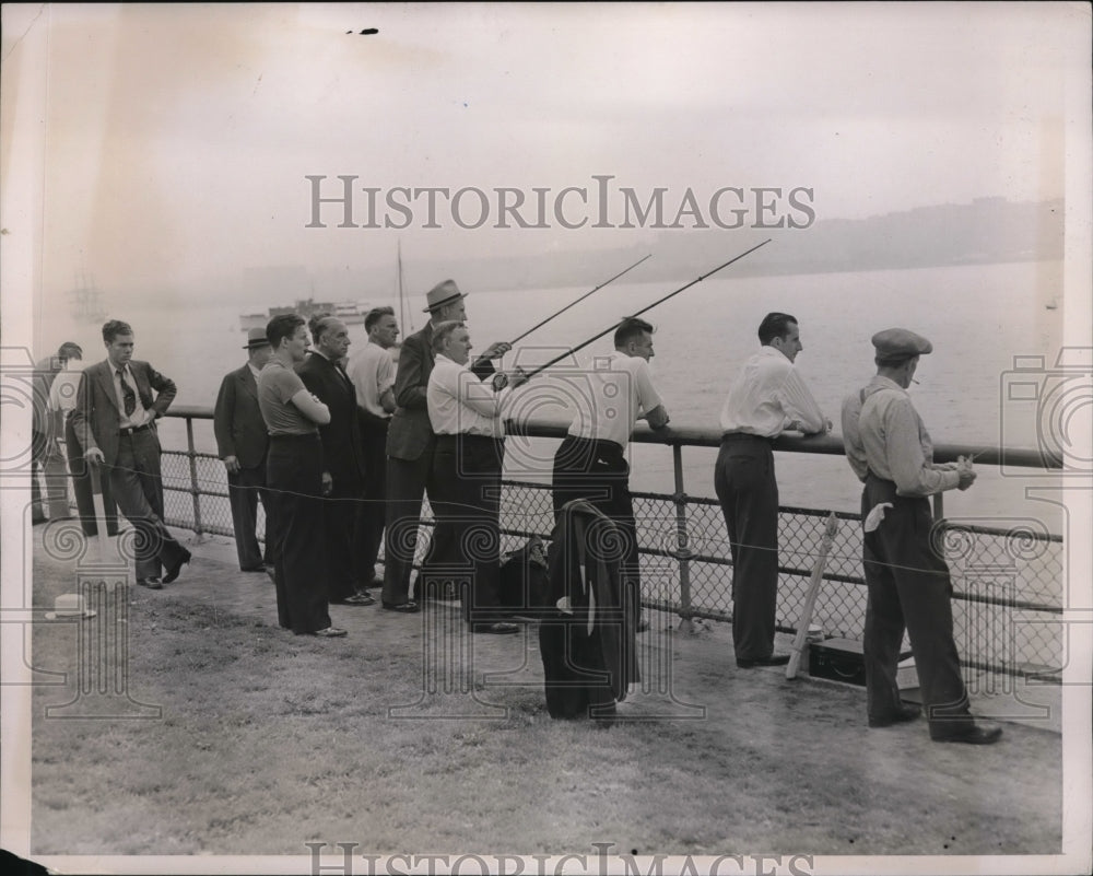 1938 Press Photo Men fishing from a lakefront pier