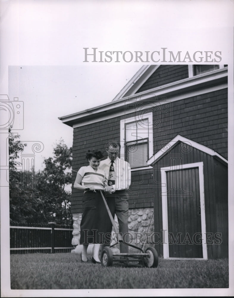 Load image into Gallery viewer, 1951 Press Photo George Fortin &amp; wife Nina mow lawn at their home
