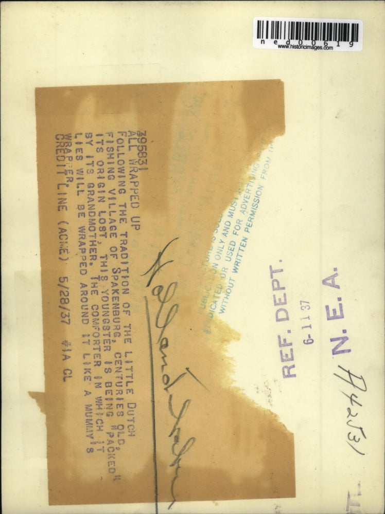 1937 Press Photo Baby being packed in Little Dutch fishing village tradition