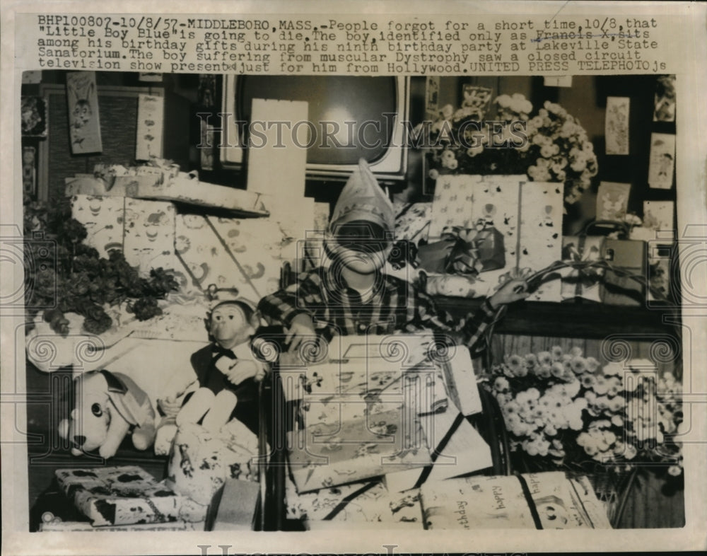 1957 Press Photo Francis X suffers from muscular dystrophy with Christmas gifts