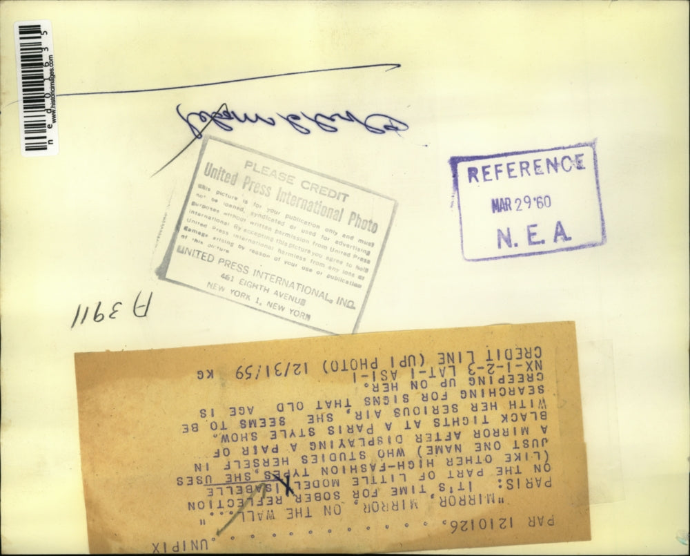 1959 Press Photo Paris Little model Isabelle studies herself in mirror