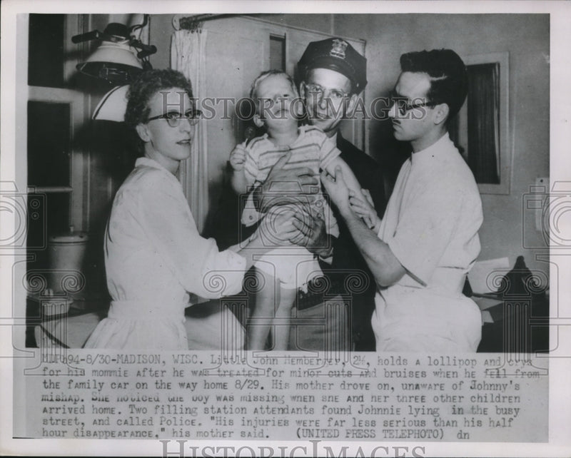 Load image into Gallery viewer, 1952 Press Photo Madison Wis J Hemberrey checked by doc after falling out of car
