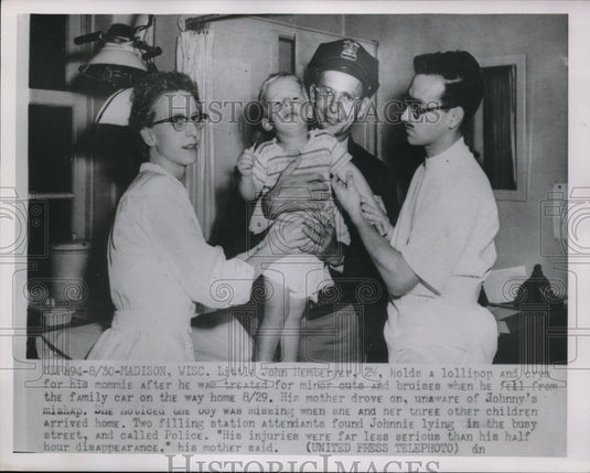 1952 Press Photo Madison Wis J Hemberrey checked by doc after falling out of car