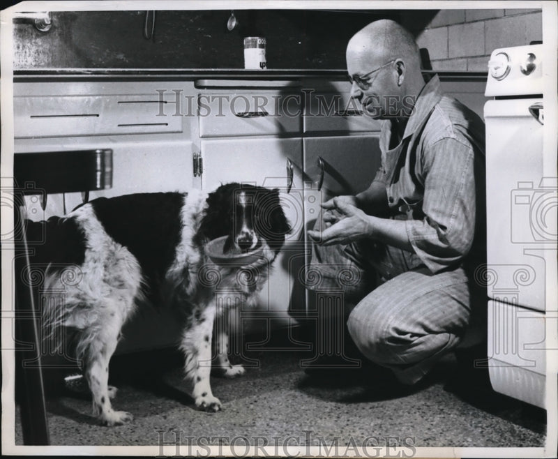 Load image into Gallery viewer, 1960 Press Photo Dog Named Smoky Brings HIs Food Dish to Fireman Earl Briggs
