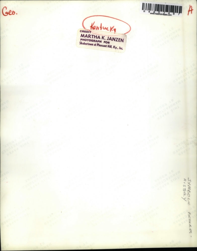 Press PhotoWoman looking at the bird & snow by the window