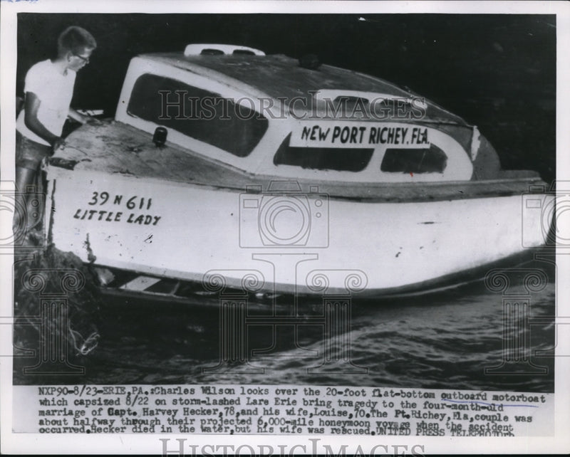 Load image into Gallery viewer, 1955 Press Photo Erie Pa Charles Wilson on his sinking boat from a storm
