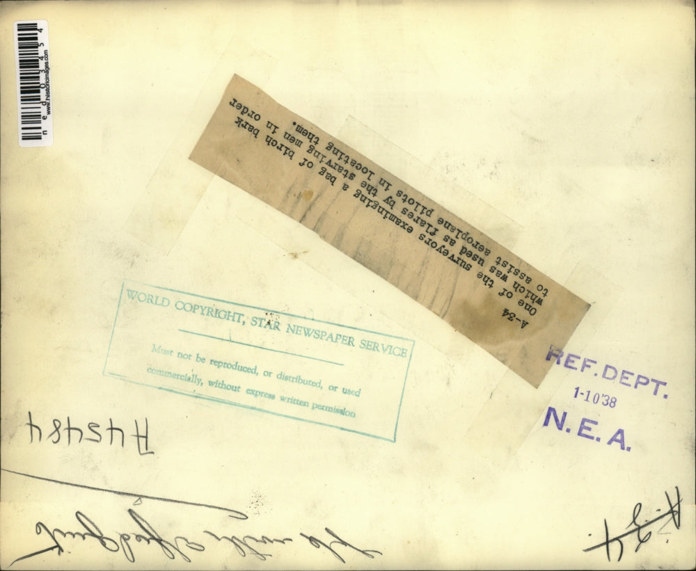 1938 Press Photo Surveyor examine birch bark used by pilots to find them in snow