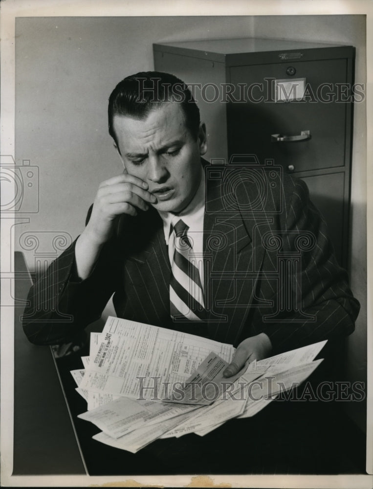 Load image into Gallery viewer, 1948 Press Photo Annake Wonders looking at his tax papers
