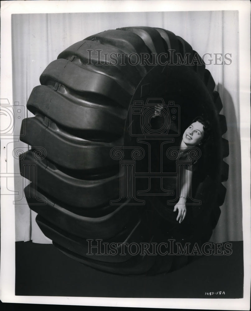 1958 Press Photo Elaine Jordaan poses in a Goodyear off road truck tire