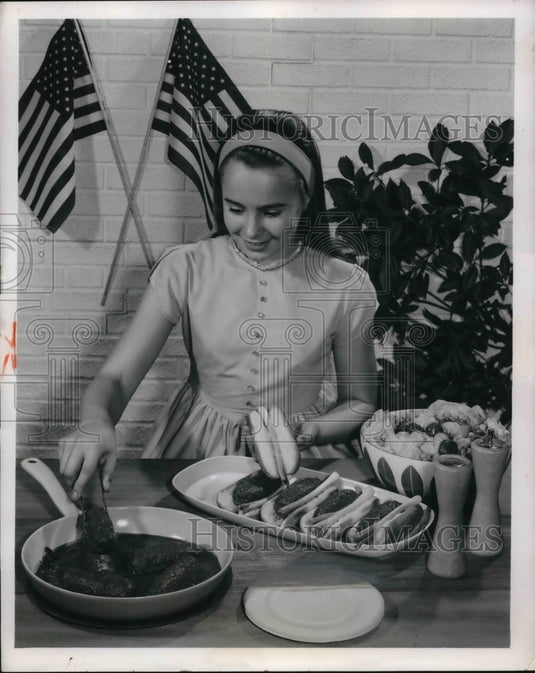 1962 Press Photo Young Miss Maddox practices cooking fire-cracker burgers