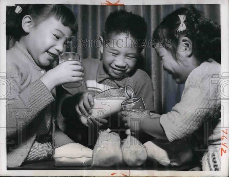 Load image into Gallery viewer, 1957 Press Photo Bangkok Thailand 3 youngsters sample milk product from new
