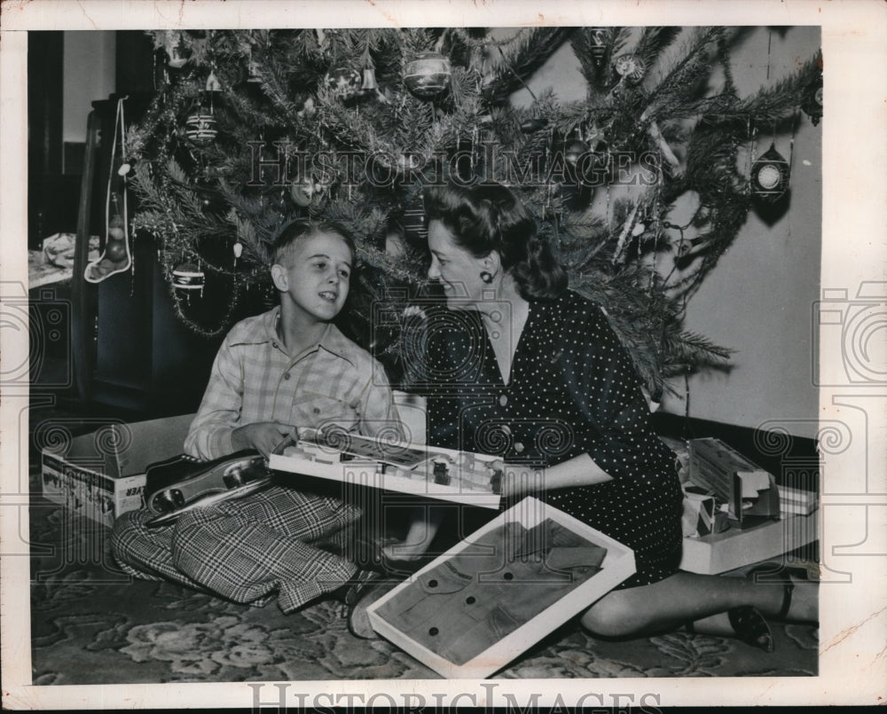1948 Press Photo Mrs. Kathleen Martin hands Christmas gifts to his son