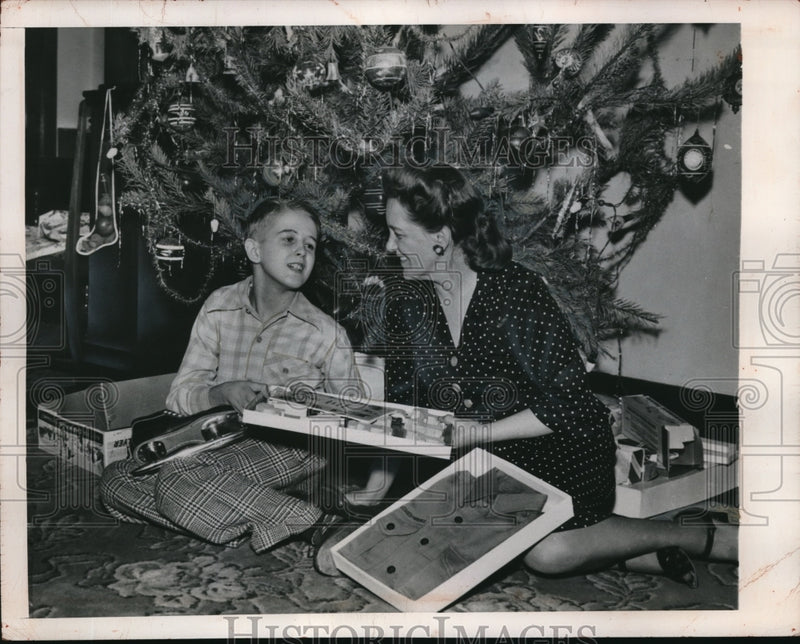 Load image into Gallery viewer, 1948 Press Photo Mrs. Kathleen Martin hands Christmas gifts to his son
