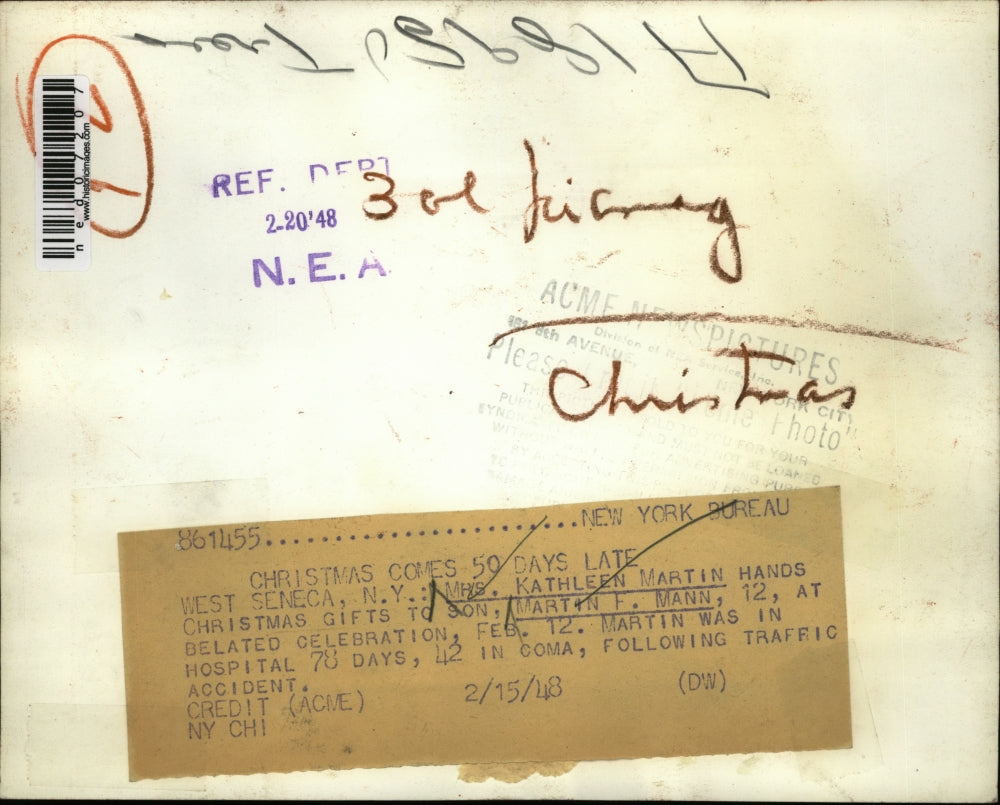 1948 Press Photo Mrs. Kathleen Martin hands Christmas gifts to his son