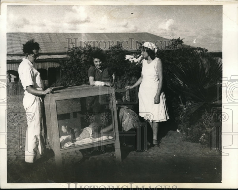 Load image into Gallery viewer, 1934 Media Photo Mother and Father Admiring Child with Caretaker
