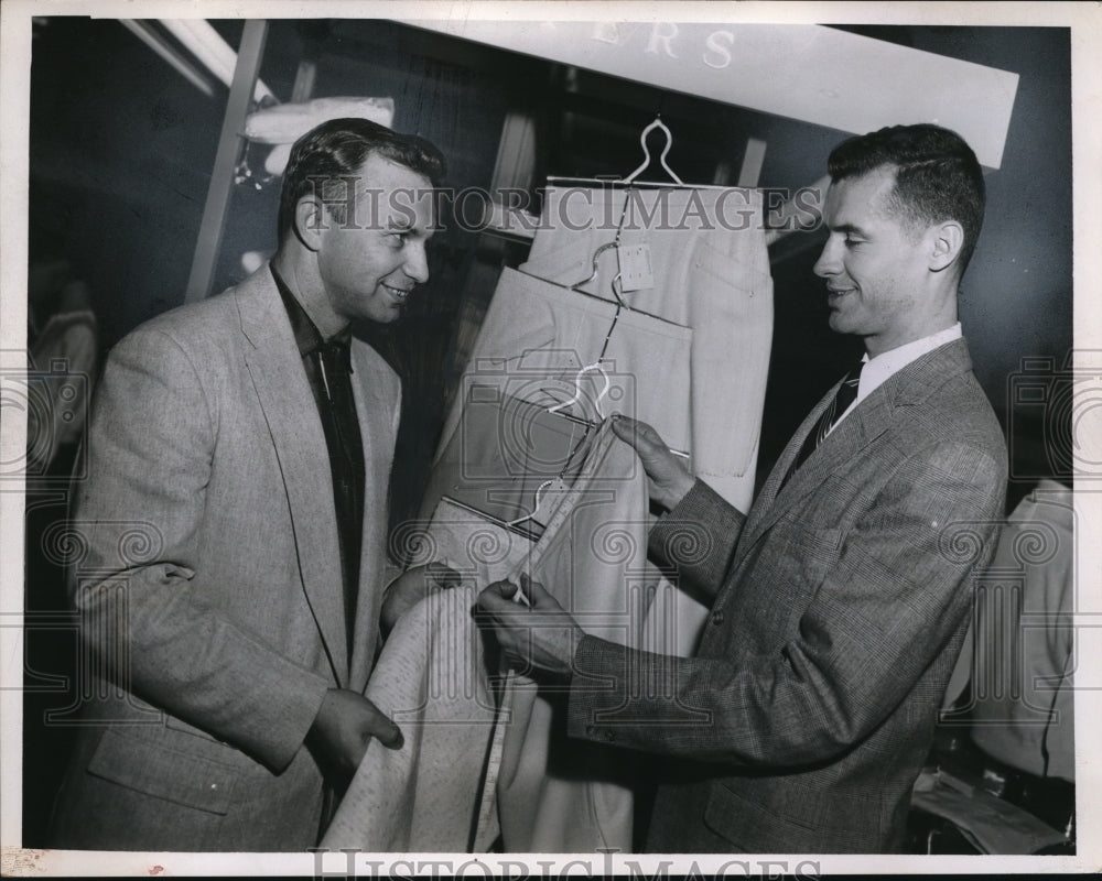 1956 Press Photo Chester Dudzinski shops for clothes and assisted by Groff