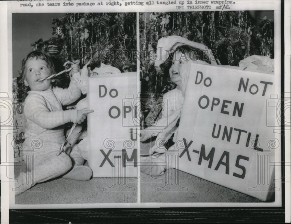 1958 Press Photo A child tears into a present that says "Do not open until X-mas