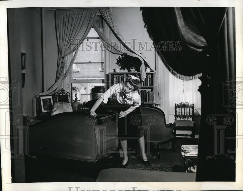 Load image into Gallery viewer, 1941 Press Photo Miss Smith re-arranging the furniture for a home cure
