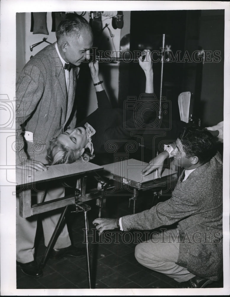 Load image into Gallery viewer, 1955 Press Photo Dr. Franklin David as he inspects a Virgin fracture table
