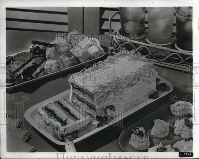 Load image into Gallery viewer, 1955 Press Photo A coconut cheese layer cake on display
