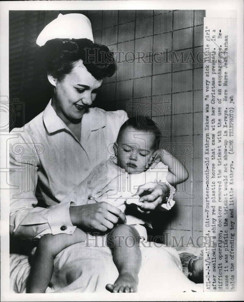 Load image into Gallery viewer, 1951 Press Photo Kathryn Eskew and Nurse Jean Parham with Toy Baby Swallowed
