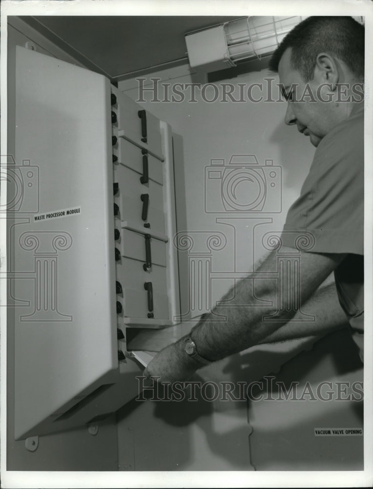 Load image into Gallery viewer, 1969 Press Photo Ralph Geiger of the NASA placed a fecal collector bag
