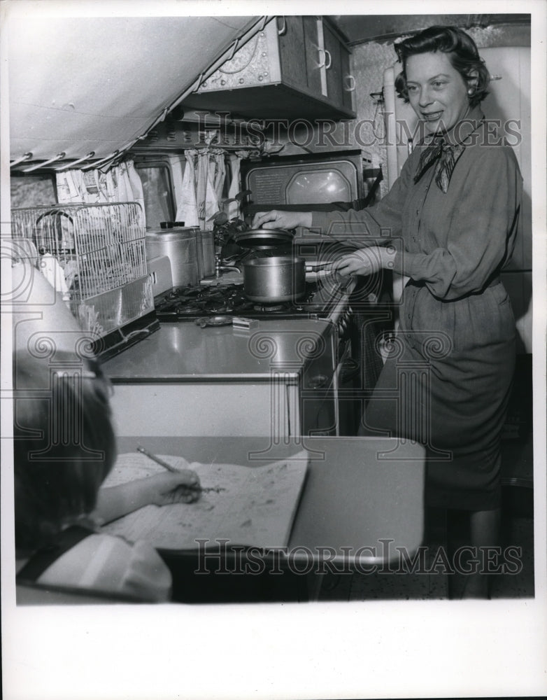 Load image into Gallery viewer, 1960 Media Photo Mrs. Waggoner cooks as bus rolls with her daughter Connie

