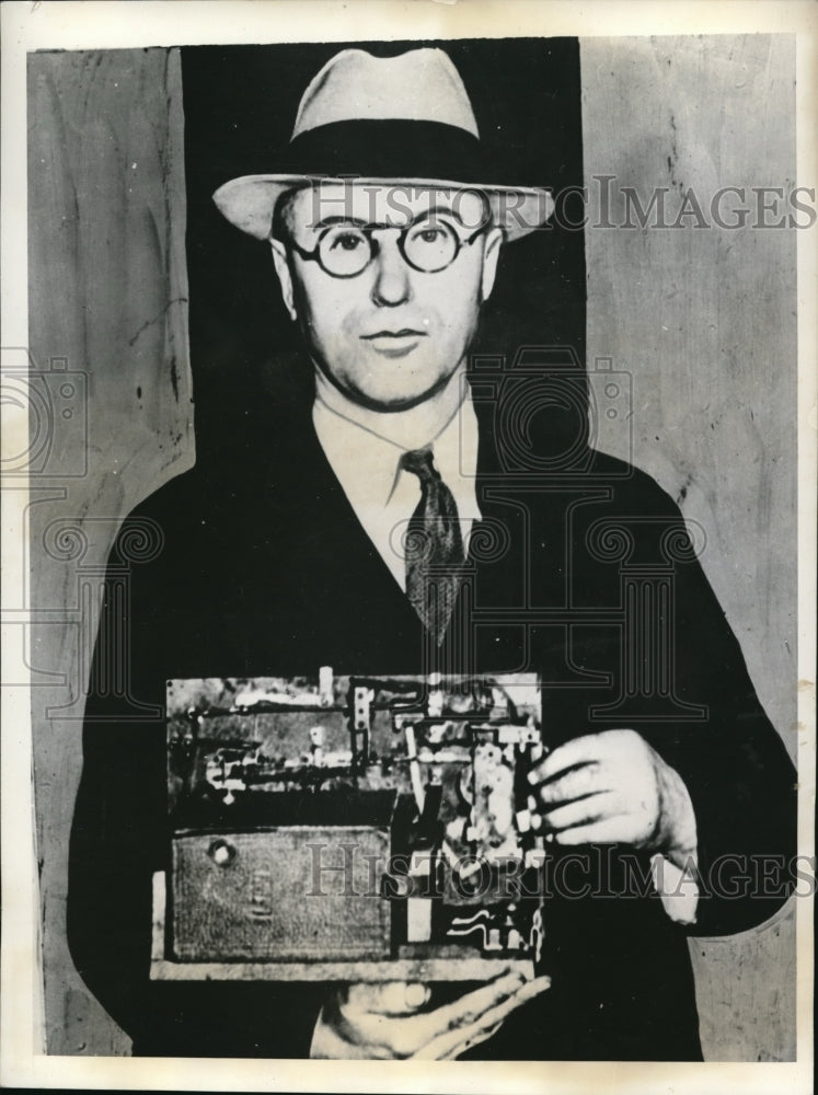 1935 Media Photo Frank Aichele with his home made alarm with camera