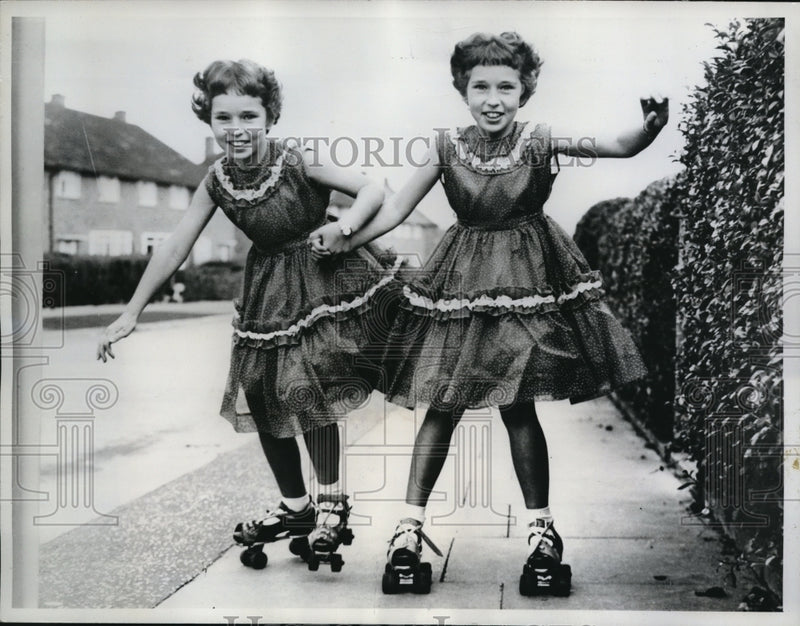 Load image into Gallery viewer, 1961 Media Photo Kathleen and Rosemary Anblow Rollerskating
