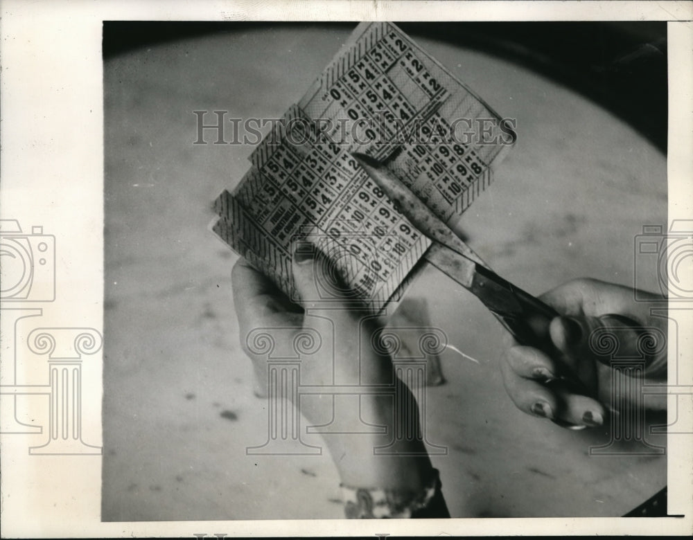 1945 Media Photo Madame Georgette clips coupons from the official ration bank