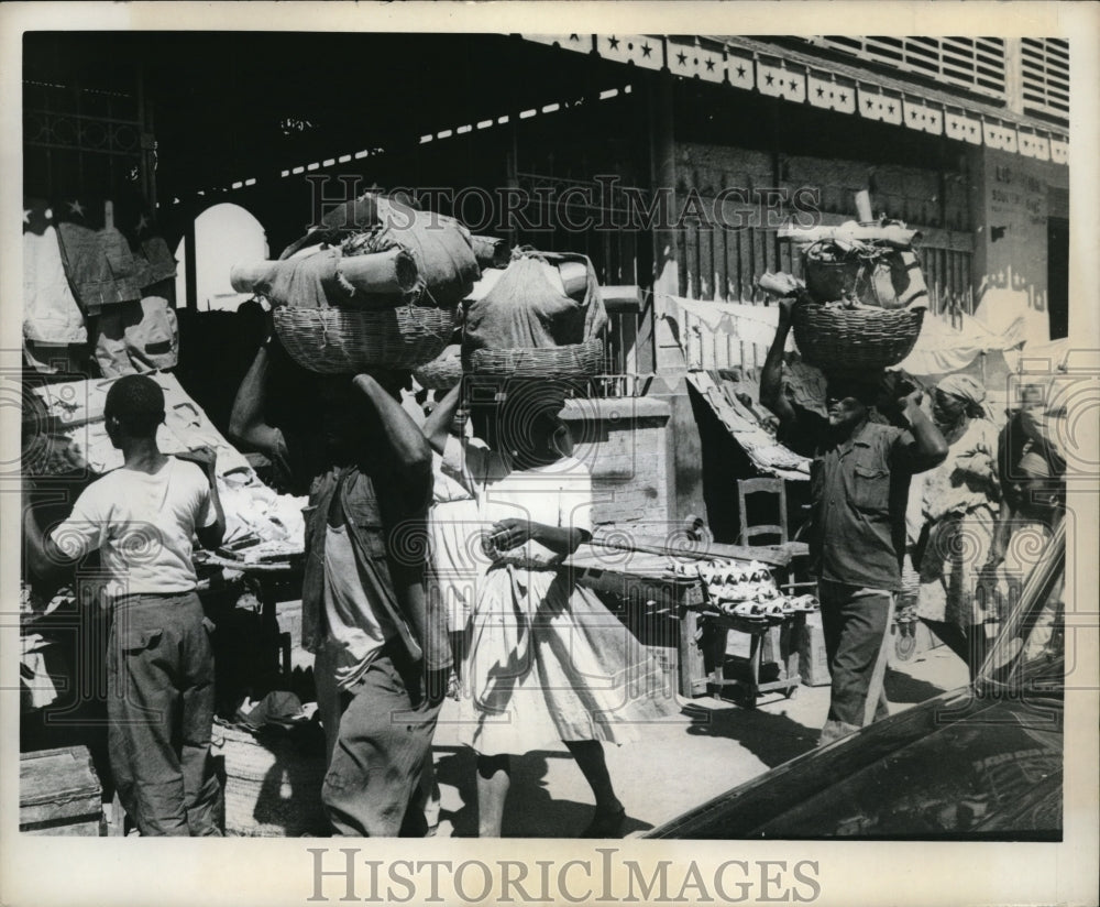 1963 Media Photo Natives carrying baskets of wares in Port-Au-Prince, Haiti