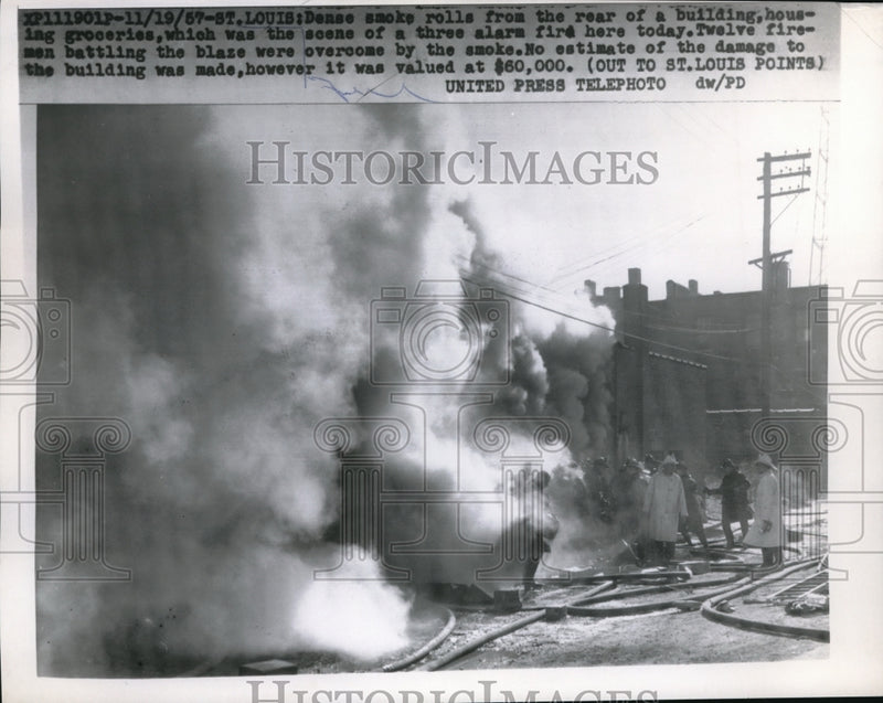 Load image into Gallery viewer, 1957 Press Photo Smoke rolling from the rear of a building housing groceries
