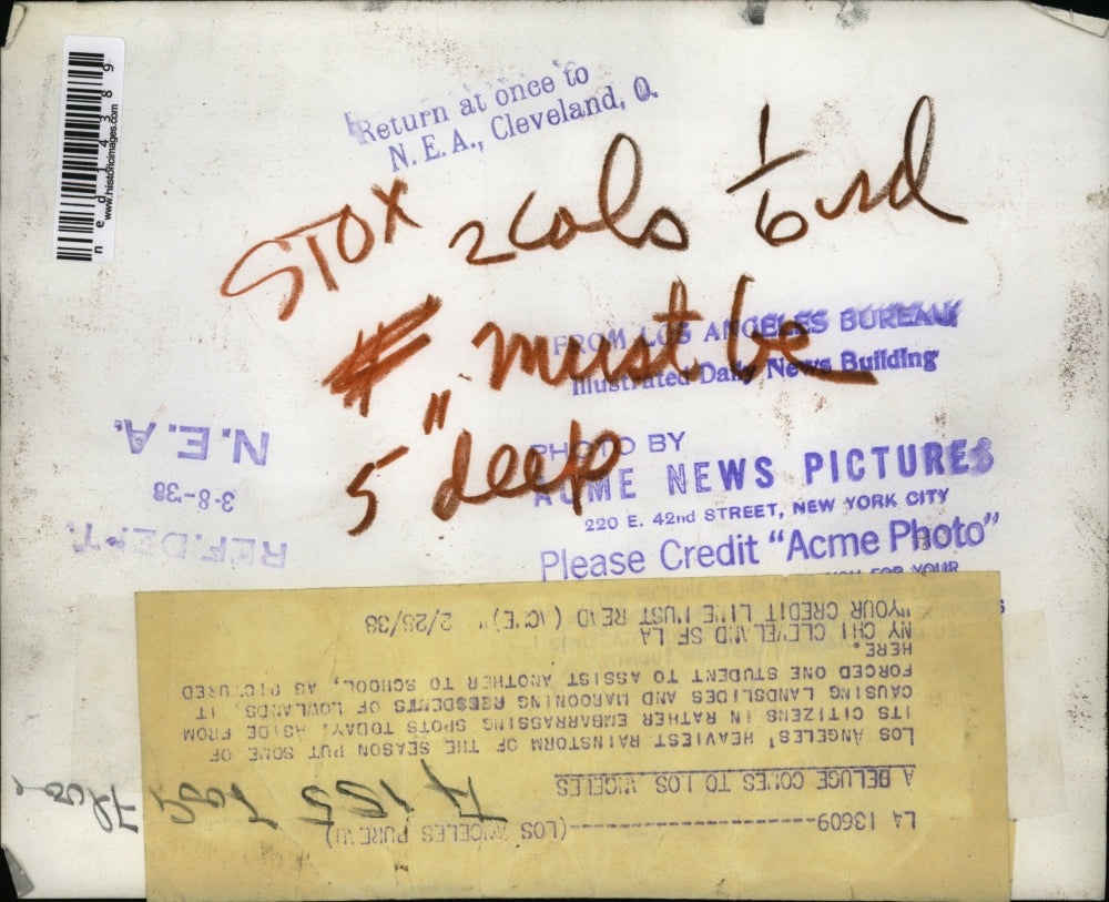 1938 Press Photo Student carries another to school in heavy rainstorm flooding