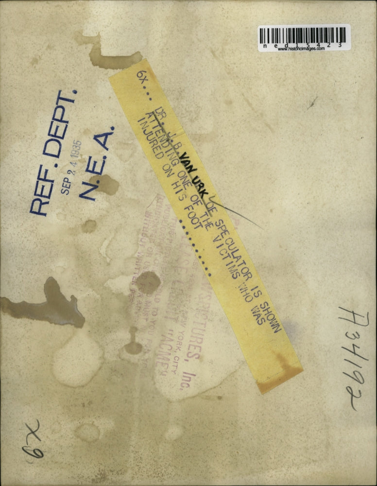 1935 Media Photo Dr JB Van Urk attends to injured foot of a man