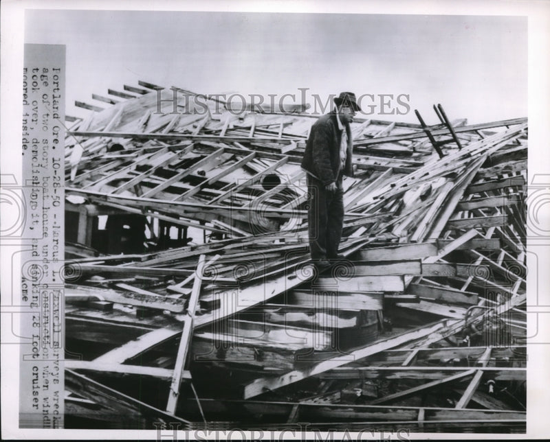 Load image into Gallery viewer, 1950 Media Photo Marcus Maxwell surveys the wreckage of a two story boat house.
