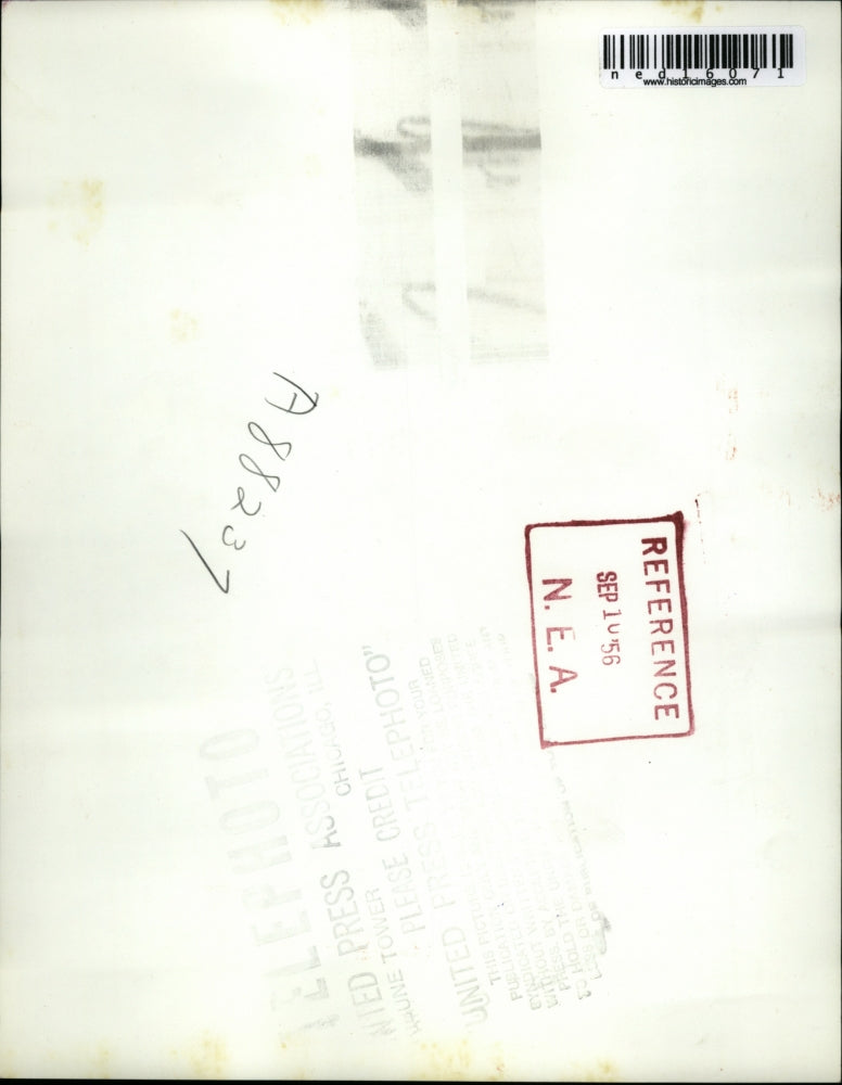 1956 Media Photo Mike Sibole waits patiently as his father ties his shoes