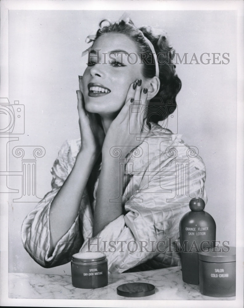 1955 Press Photo Model showing how to take care of her face