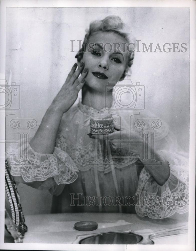 1955 Press Photo Facial mask is smoothed on, dries, and is removed with water