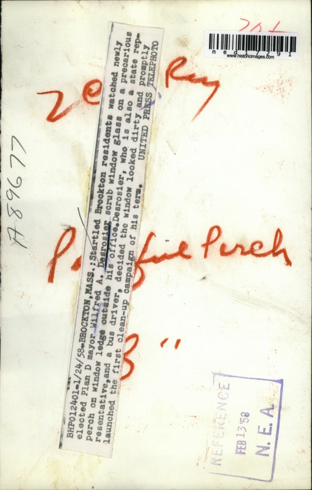 1958 Press Photo Wilfred A. Desrosier Scrubs A Window Outside Of His Office